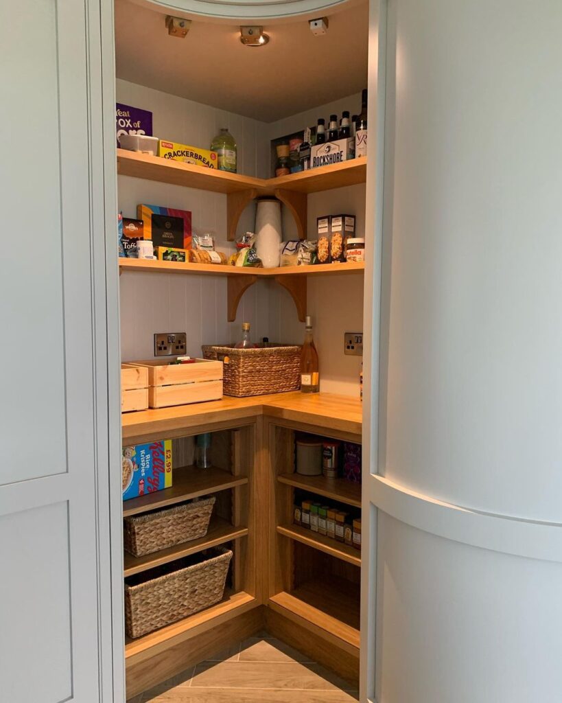 How A Kitchen Pantry Will Change Your Life -Compact corner kitchen pantry with wooden shelves, storage baskets, and organized pantry essentials for efficient storage and easy access